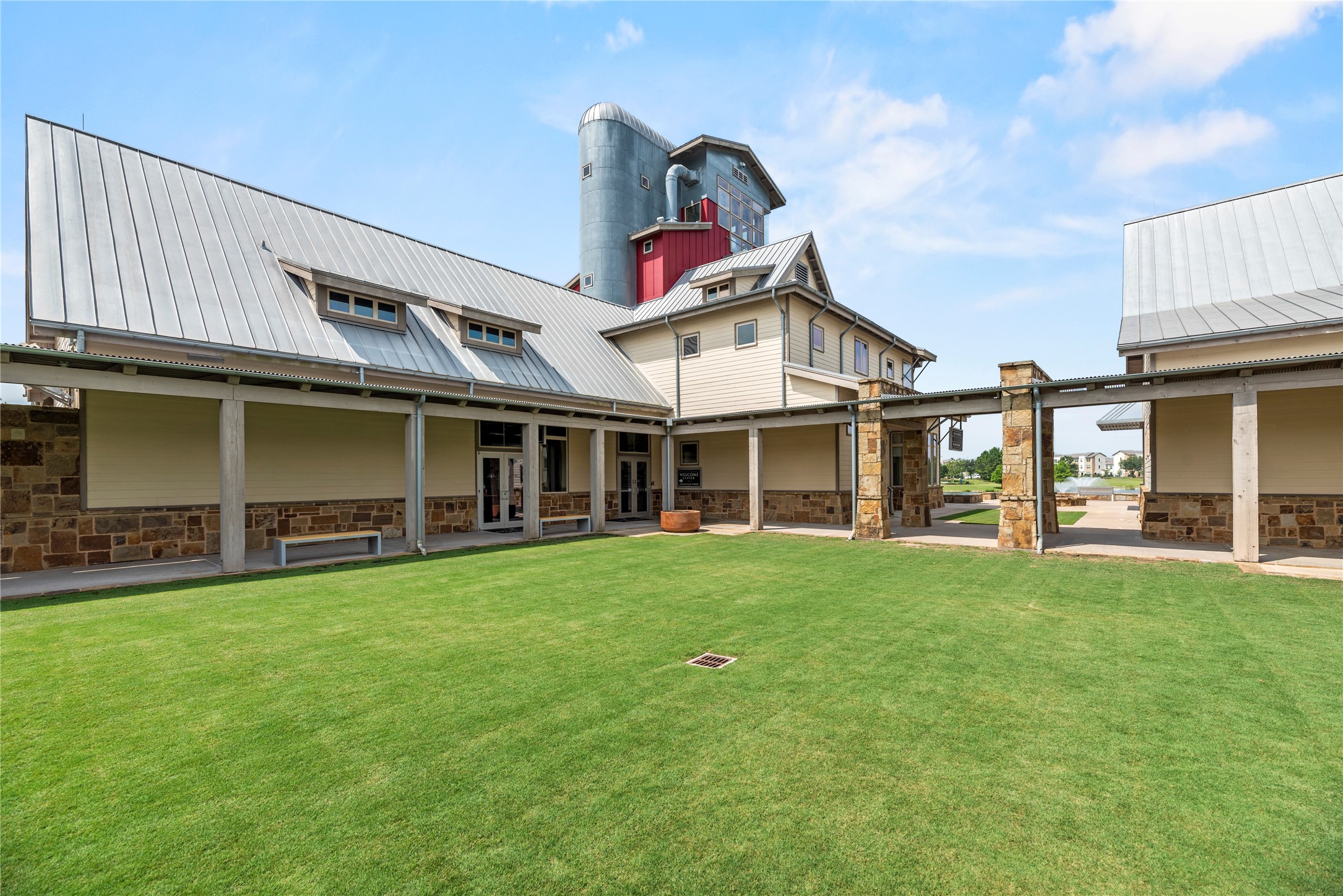 5827 Amherst Farms Lane Fulshear, TX 77441 - Photo 47 of 48 The Cross Creek Ranch Ranch House showcases a unique blend of Texas Hill Country stonework and modern farmhouse design. Expansive covered walkways, gathering spaces, and thoughtfully designed architecture make this the heart of the community’s social life.