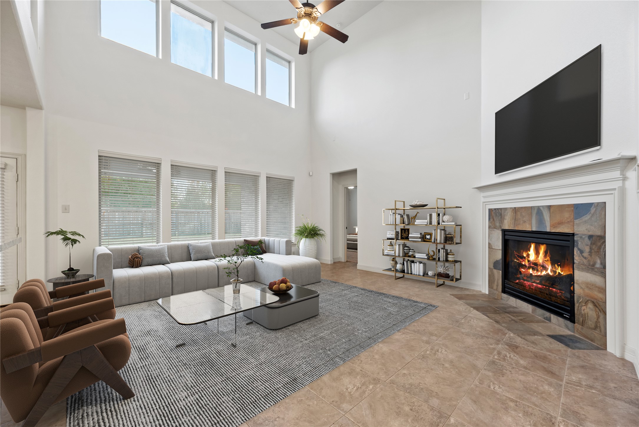 5827 Amherst Farms Lane Fulshear, TX 77441 - Photo 7 of 48 This virtually staged view highlights the soaring two-story family room, anchored by a gas-log fireplace with a detailed mantel. Upper windows flood the space with natural light, while the open layout offers flexible living and an airy, inviting feel.