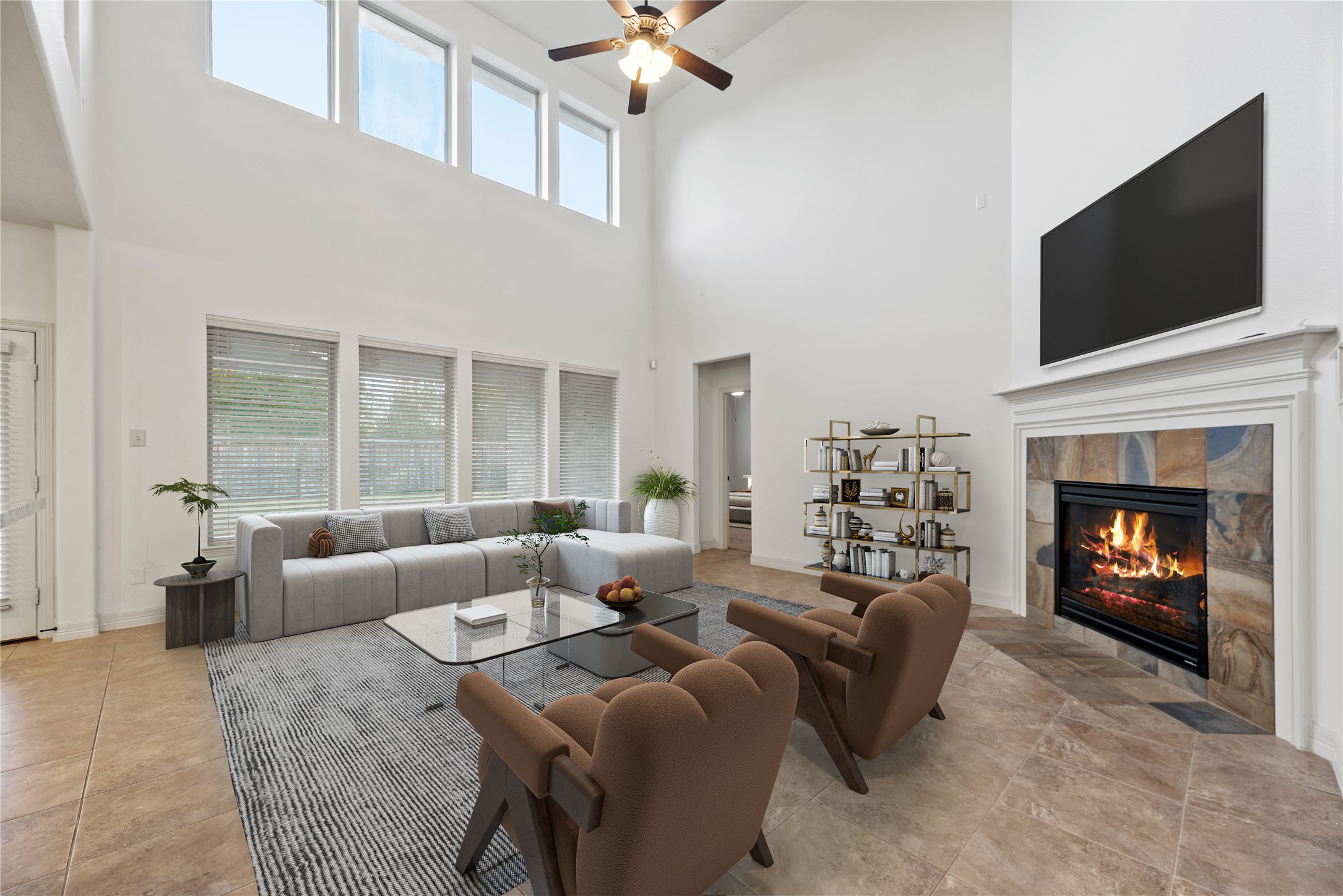 5827 Amherst Farms Lane Fulshear, TX 77441 - Photo 8 of 48 An alternate staged view showcases the room’s generous scale and entertaining potential. Seating frames the fireplace, while soaring ceilings and high windows enhance the bright, open feel.