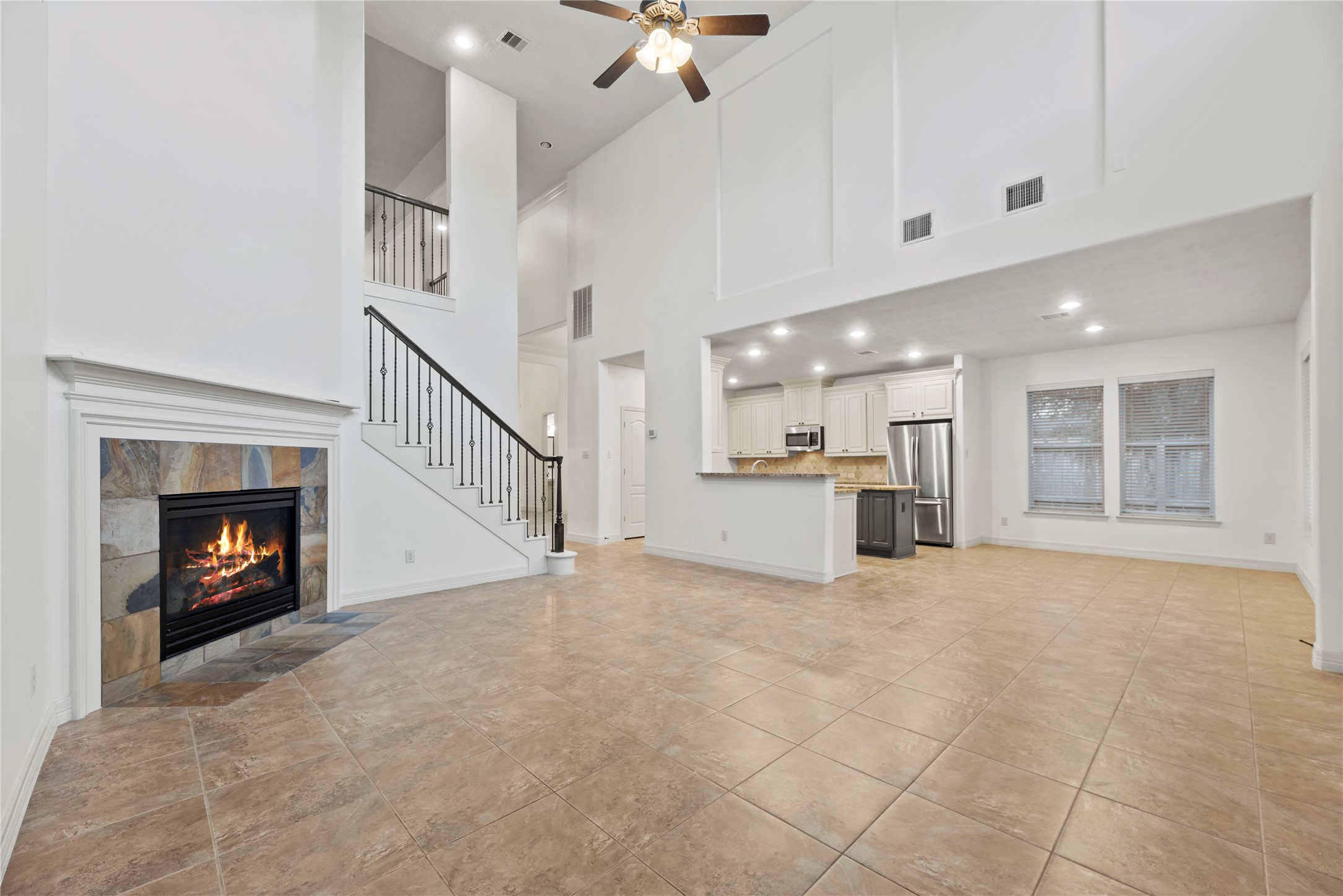5827 Amherst Farms Lane Fulshear, TX 77441 - Photo 9 of 48 This wide-angle view captures the seamless flow between the family room, kitchen & dining area.