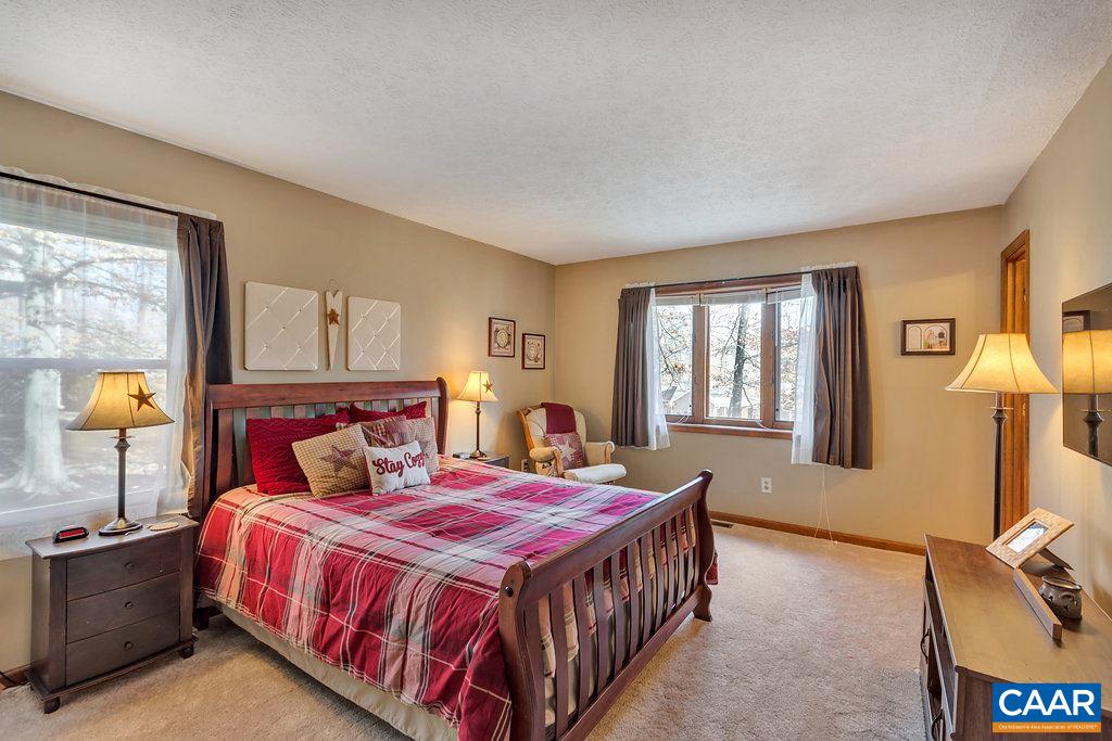 30 East Point Road Palmyra, VA 22963 - Photo 17 of 38 a bedroom with a bed and lamp with window