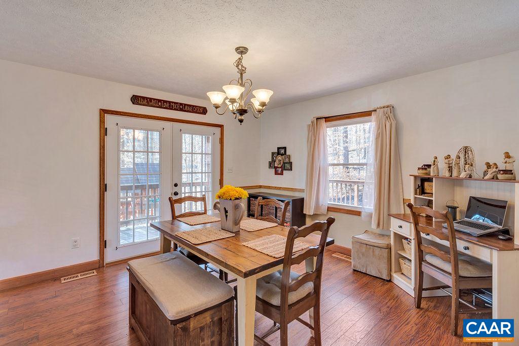 30 East Point Road Palmyra, VA 22963 - Photo 10 of 38 a living room with furniture a chandelier and a window