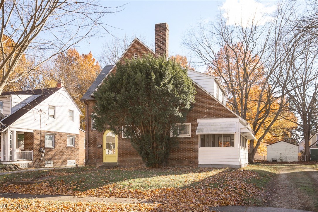 1604 Hampton Road Akron, OH 44305 - Photo 4 of 30 View of property exterior featuring a chimney, brick siding, and a sunroom