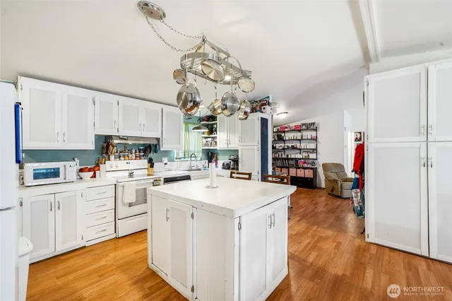 a kitchen with cabinets a sink and appliances