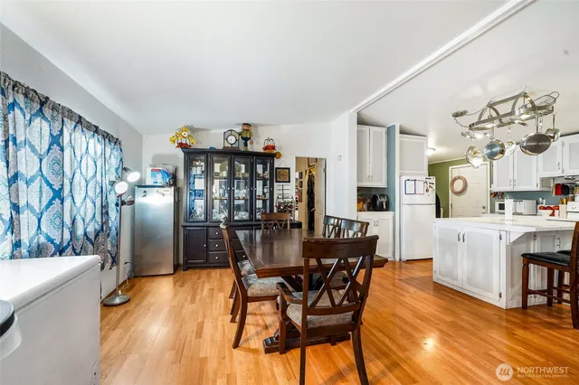 a view of a dining room with furniture and chandelier