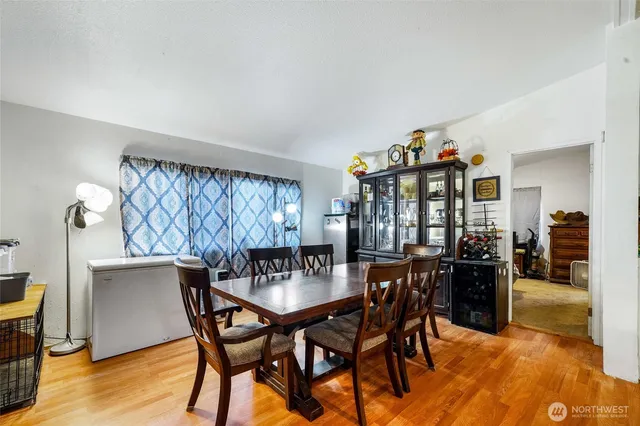 a dining room with furniture and wooden floor