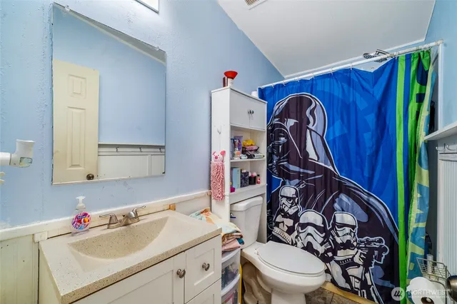 a bathroom with a sink toilet and mirror