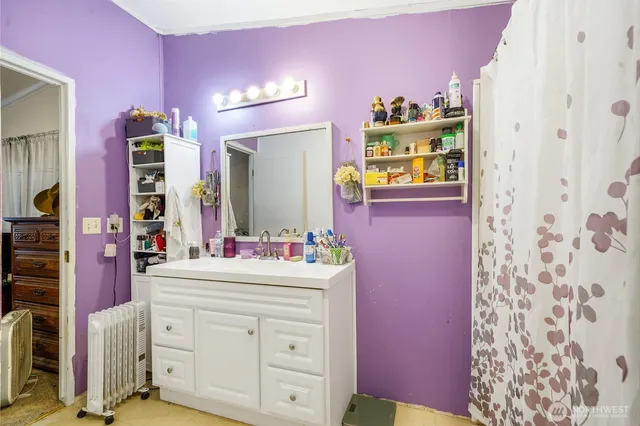 a bathroom with a sink vanity and mirror