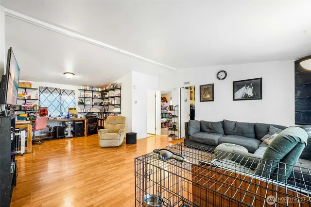 a living room with furniture and a wooden floor