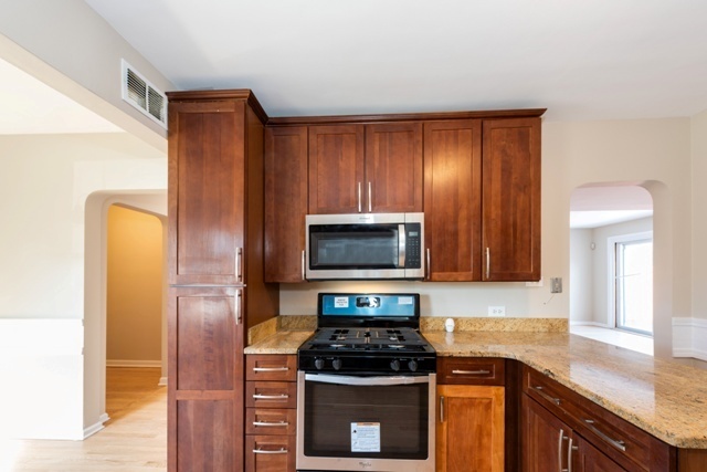 1111 Webster Lane Des Plaines, IL 60016 - Photo 3 of 25 a kitchen with a stove microwave and refrigerator