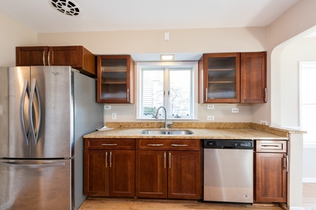 1111 Webster Lane Des Plaines, IL 60016 - Photo 4 of 25 a kitchen with stainless steel appliances granite countertop a refrigerator a sink and a stove