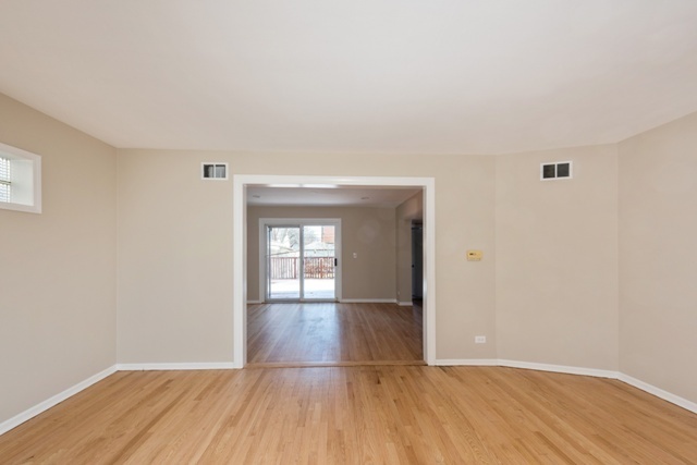1111 Webster Lane Des Plaines, IL 60016 - Photo 7 of 25 wooden floor in an empty room with a window