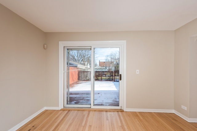 1111 Webster Lane Des Plaines, IL 60016 - Photo 9 of 25 wooden floor in an empty room with a window