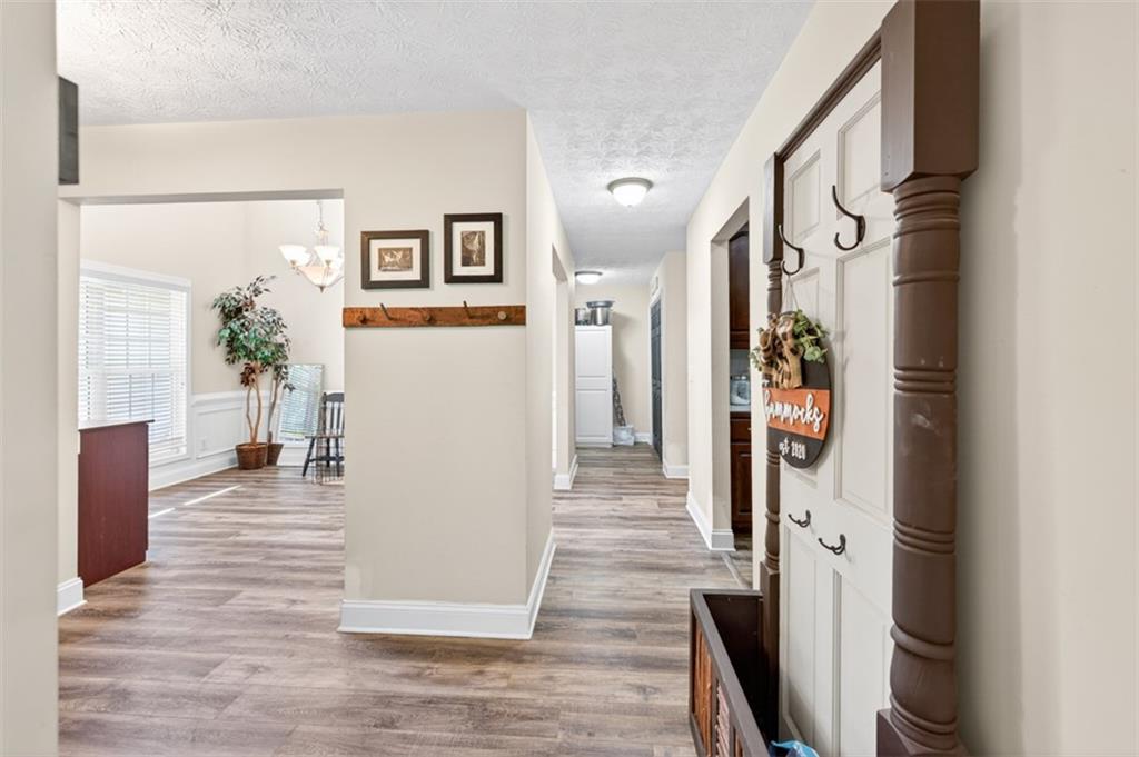 89 Katie Spring Lane Jefferson, GA 30549 - Photo 22 of 63 a view of a hallway with wooden floor and dining room