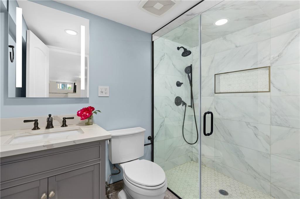 552 77th Street Brooklyn, NY 11209 - Photo 11 of 14 a bathroom with a sink toilet and shower