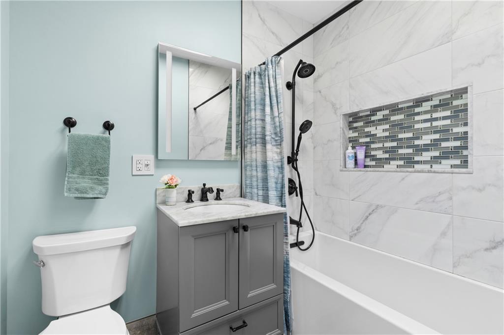 552 77th Street Brooklyn, NY 11209 - Photo 12 of 14 a bathroom with a sink toilet and shower