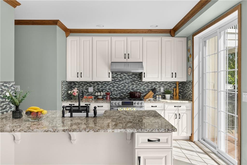 552 77th Street Brooklyn, NY 11209 - Photo 3 of 14 a kitchen with stainless steel appliances granite countertop a sink stove and cabinets