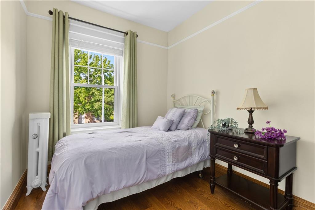 552 77th Street Brooklyn, NY 11209 - Photo 10 of 14 a bedroom with a bed and a window