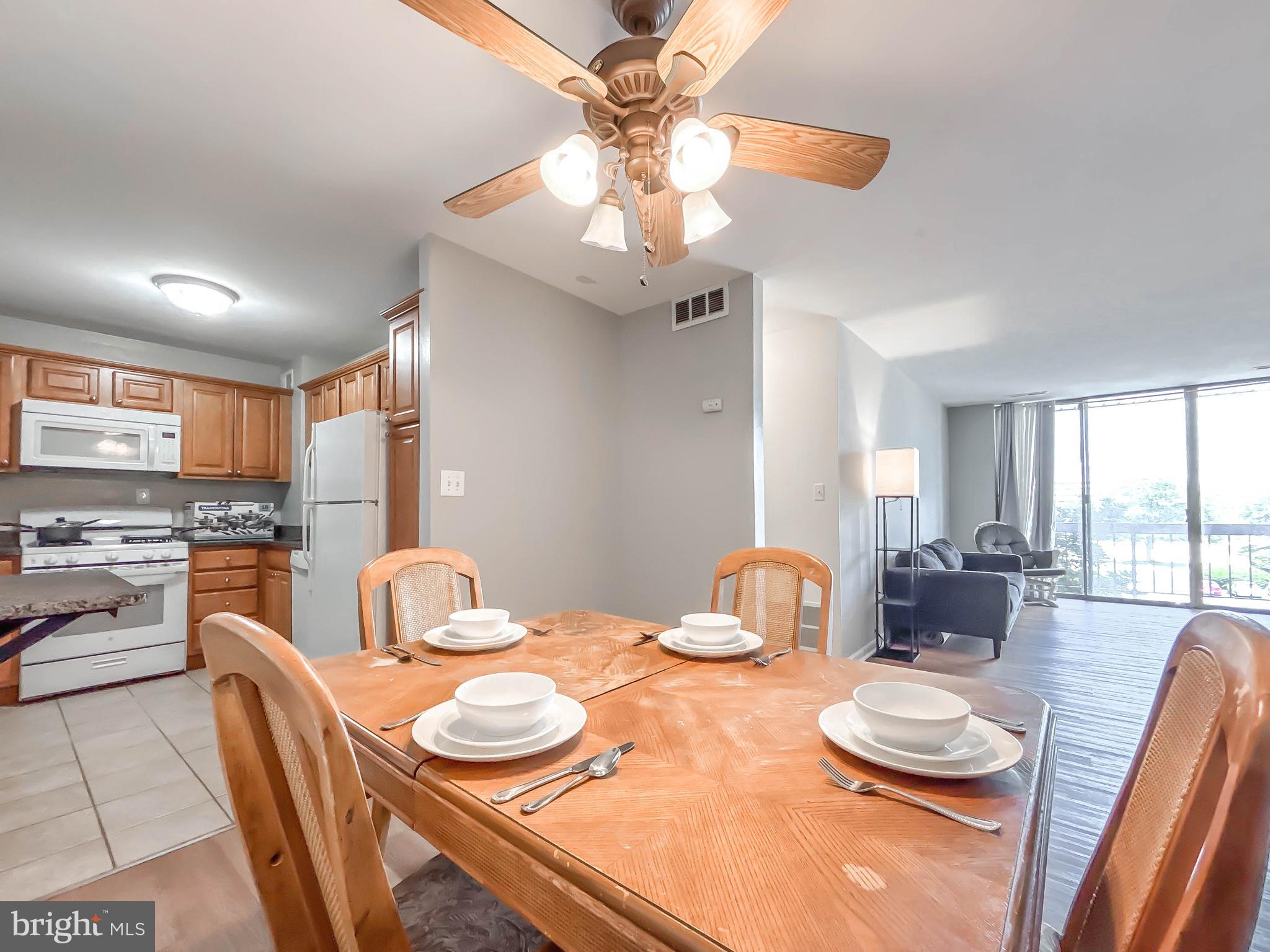 130 Slade Avenue, Unit 414 Baltimore, MD 21208 - Photo 42 of 48 a dining room with furniture and a view of kitchen
