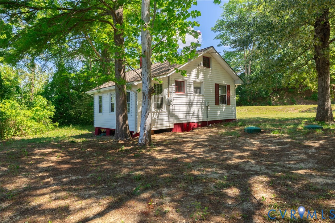 933 Pleasant Point Road Surry, VA 23883 - Photo 21 of 45 a view of a house with a yard and large tree