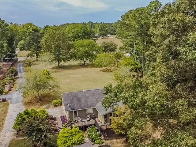 an aerial view of a house with a lake view
