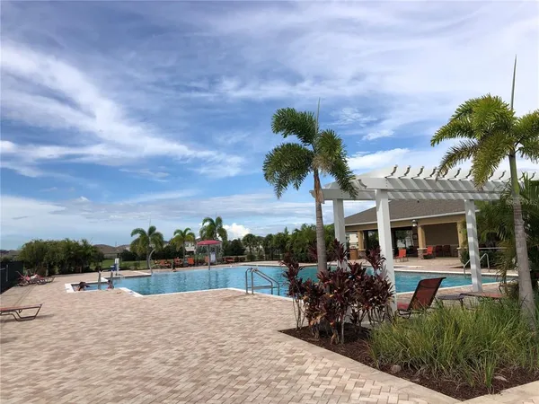 a view of a house with yard and lake view