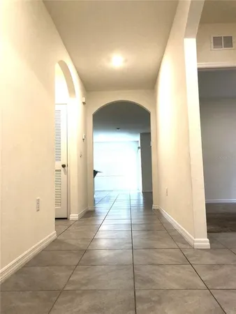 a view of a hallway with wooden shelves