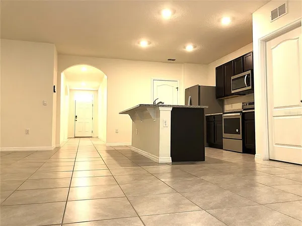 a kitchen with stainless steel appliances granite countertop a refrigerator and a cabinets