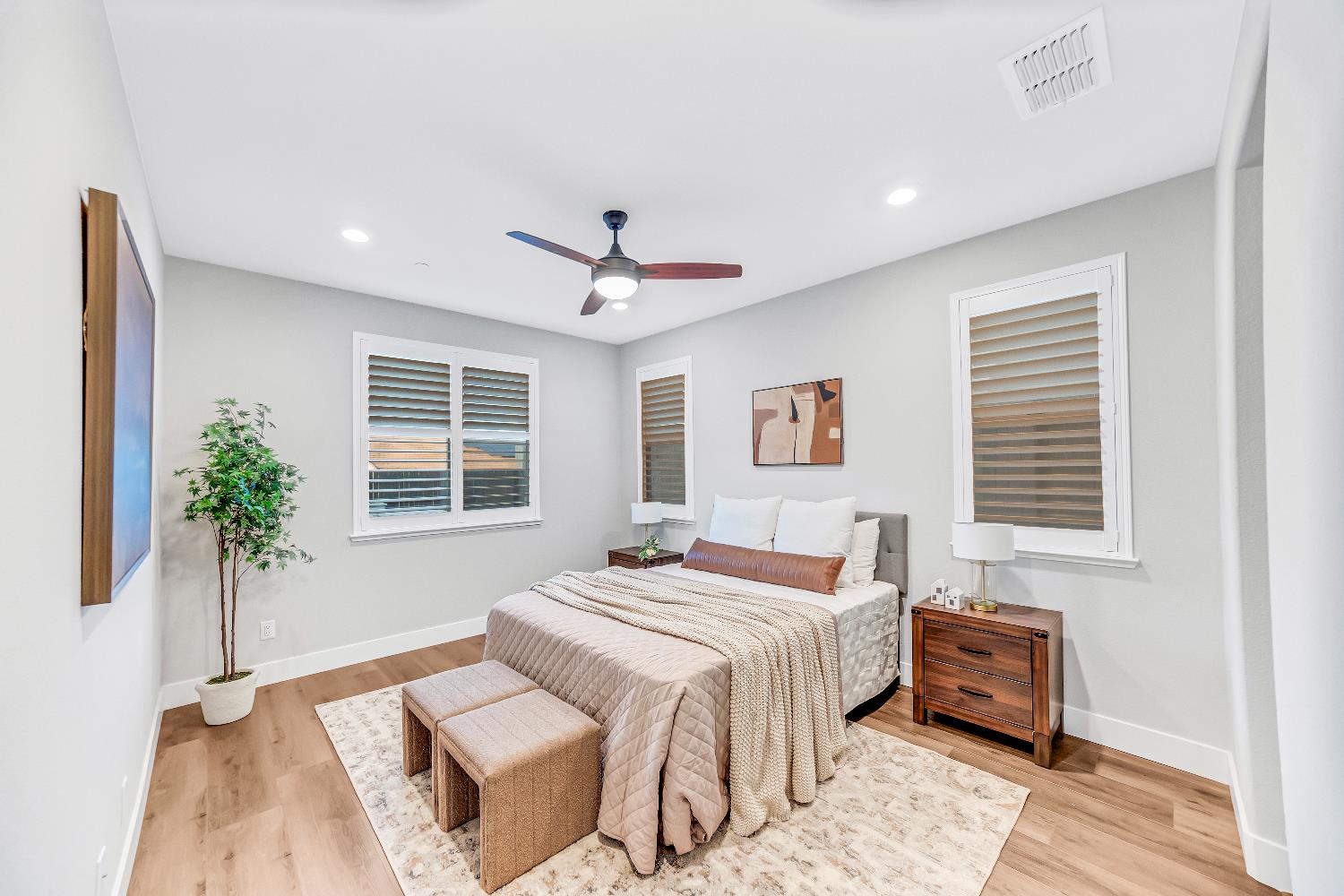 2947 Laredo Drive Rocklin, CA 95765 - Photo 12 of 65 a bedroom with a large bed and a potted plant