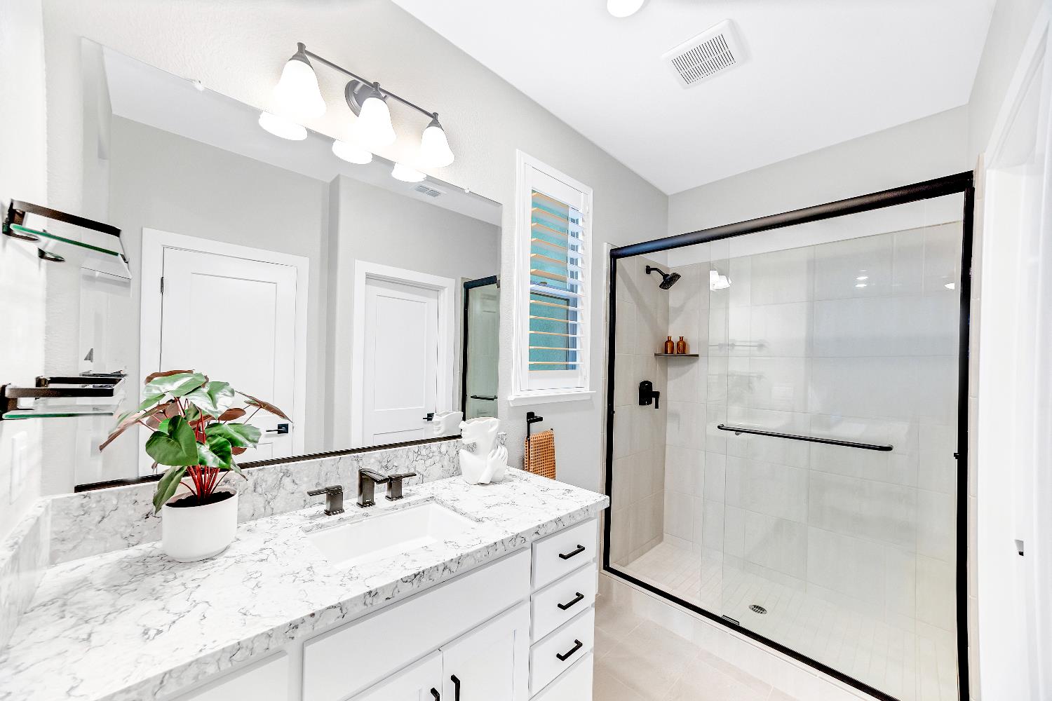 2947 Laredo Drive Rocklin, CA 95765 - Photo 13 of 65 a bathroom with a granite countertop sink a mirror and shower