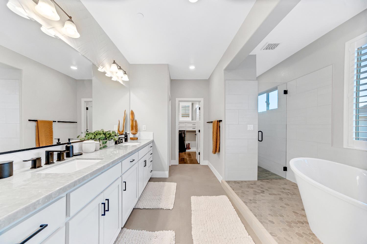2947 Laredo Drive Rocklin, CA 95765 - Photo 26 of 65 a large bathroom with a granite countertop tub a double vanity sink a mirror and a shower