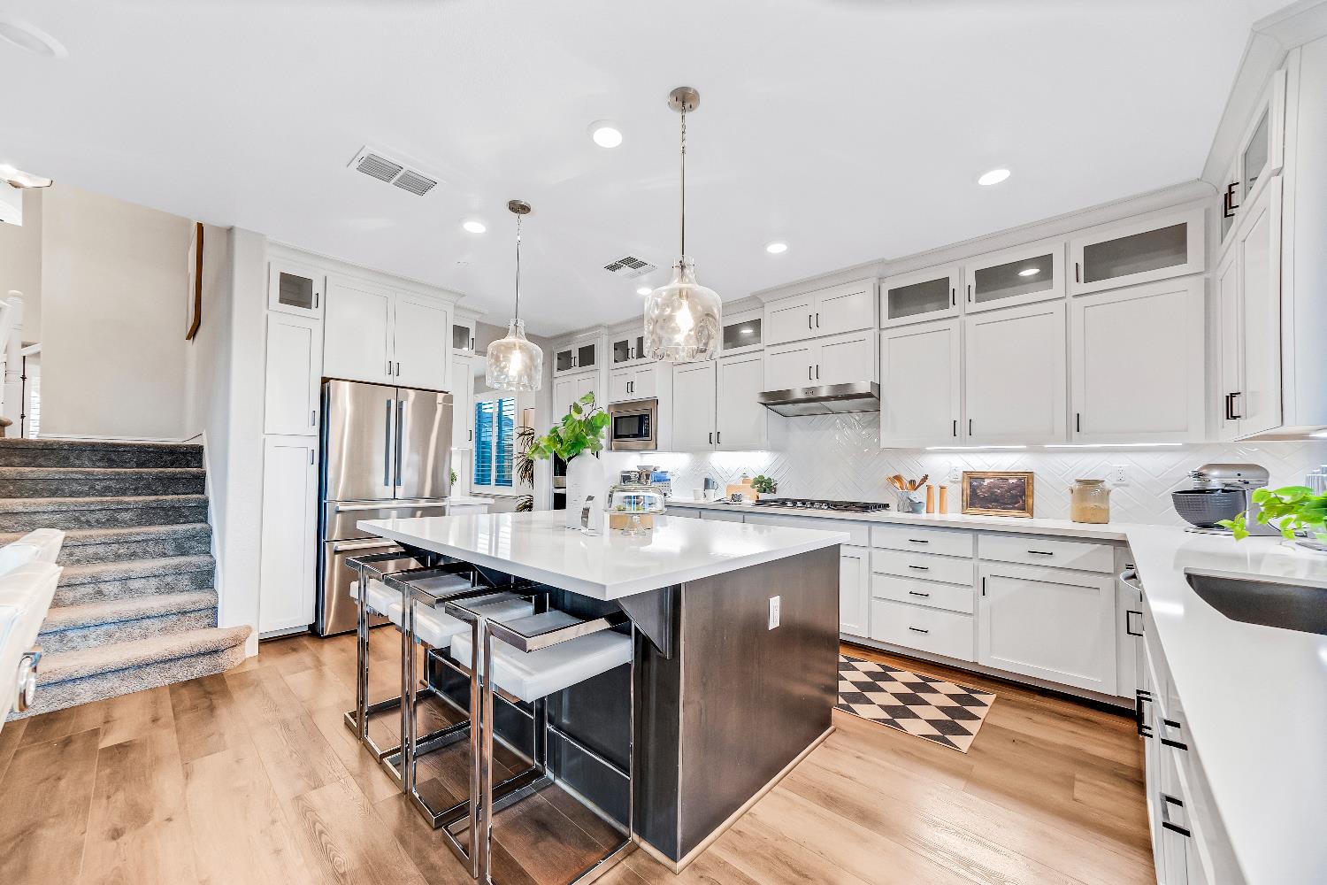 2947 Laredo Drive Rocklin, CA 95765 - Photo 45 of 65 a kitchen with stainless steel appliances kitchen island granite countertop a sink cabinets and wooden floor