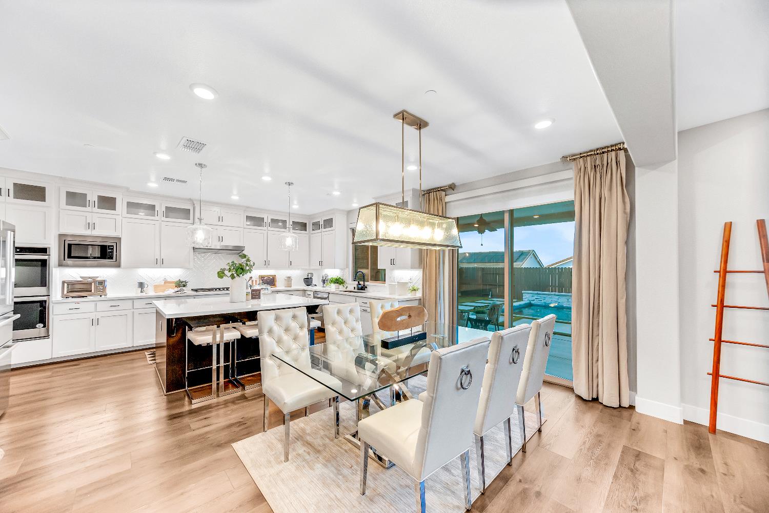 2947 Laredo Drive Rocklin, CA 95765 - Photo 46 of 65 a dining room with furniture a chandelier and wooden floor