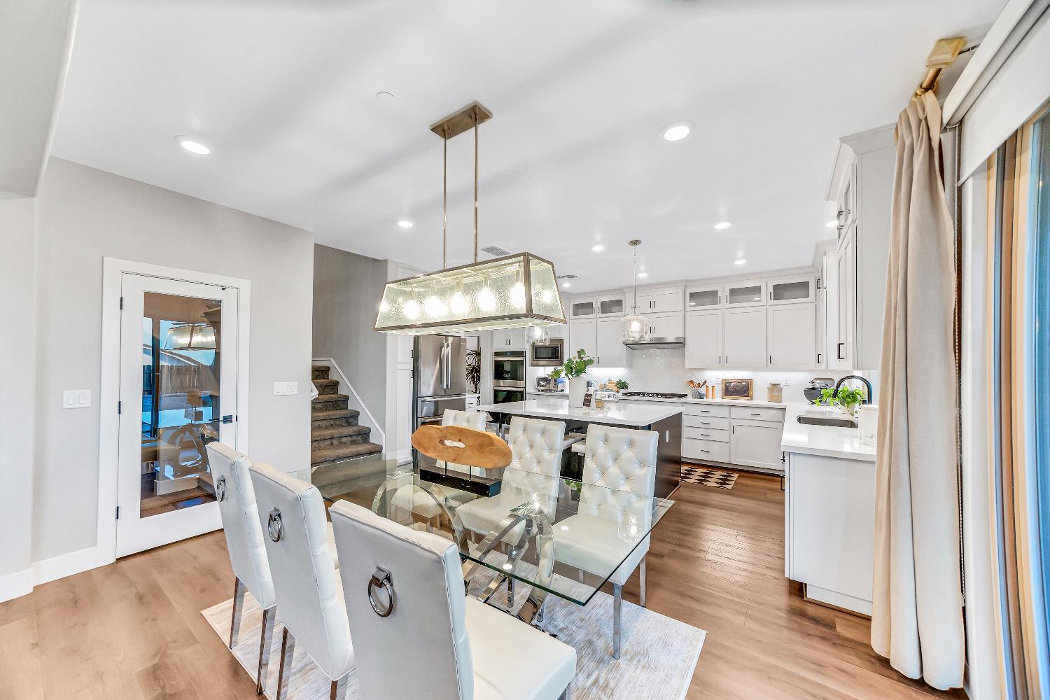 2947 Laredo Drive Rocklin, CA 95765 - Photo 47 of 65 a view of a dining room and livingroom with furniture wooden floor a chandelier