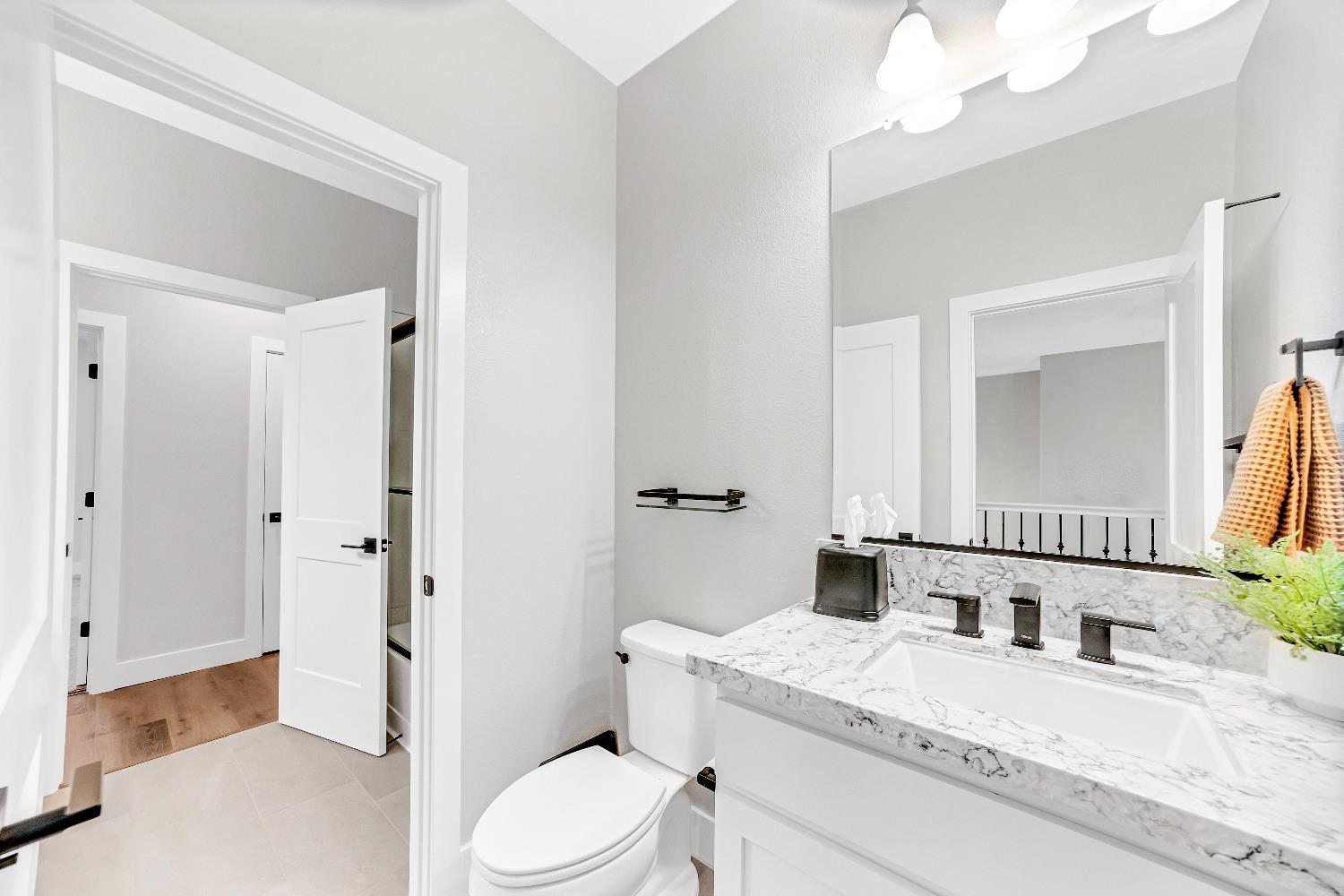 2947 Laredo Drive Rocklin, CA 95765 - Photo 55 of 65 a bathroom with a granite countertop sink mirror vanity and toilet