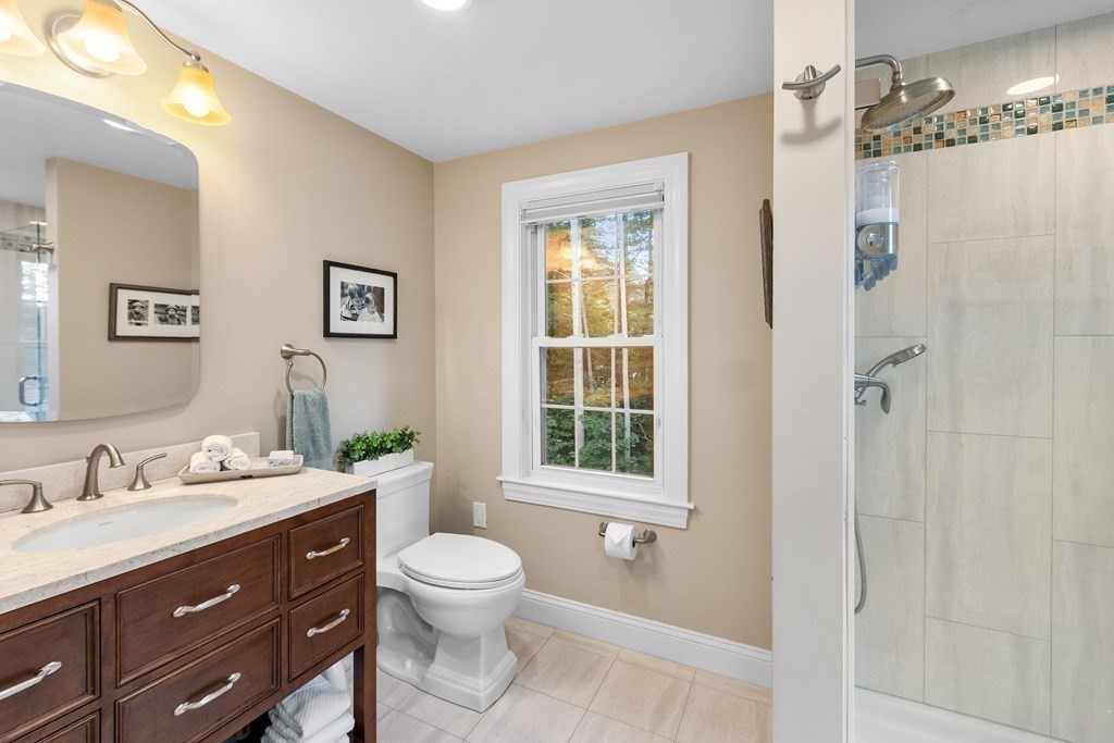 21 Oneida Road Acton, MA 01720 - Photo 24 of 39 a bathroom with a toilet a sink a window and a mirror
