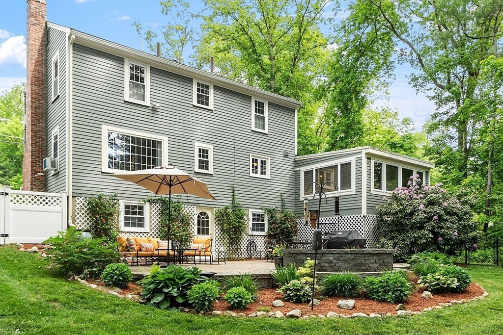 21 Oneida Road Acton, MA 01720 - Photo 3 of 39 a front view of a house with a yard and potted plants