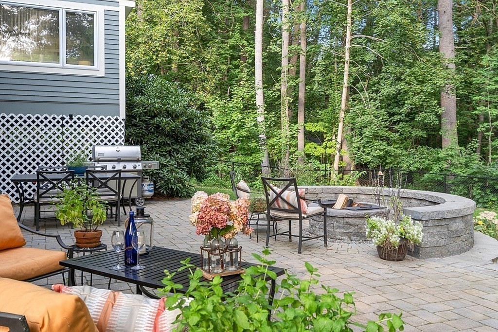 21 Oneida Road Acton, MA 01720 - Photo 5 of 39 a view of a patio with table and chairs potted plants