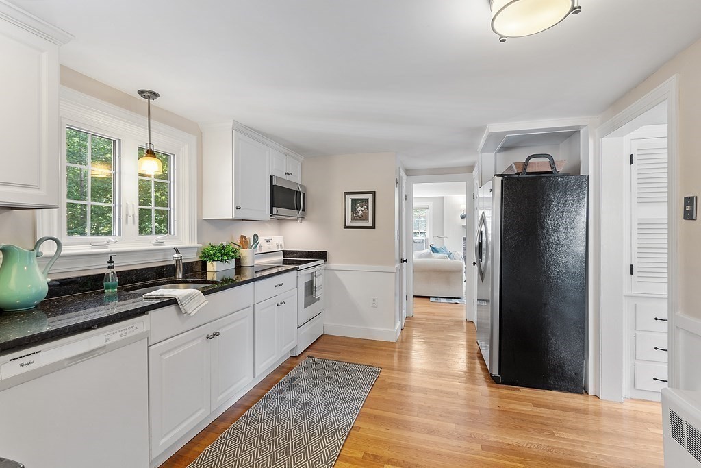 21 Oneida Road Acton, MA 01720 - Photo 9 of 39 a large kitchen with a refrigerator and a sink