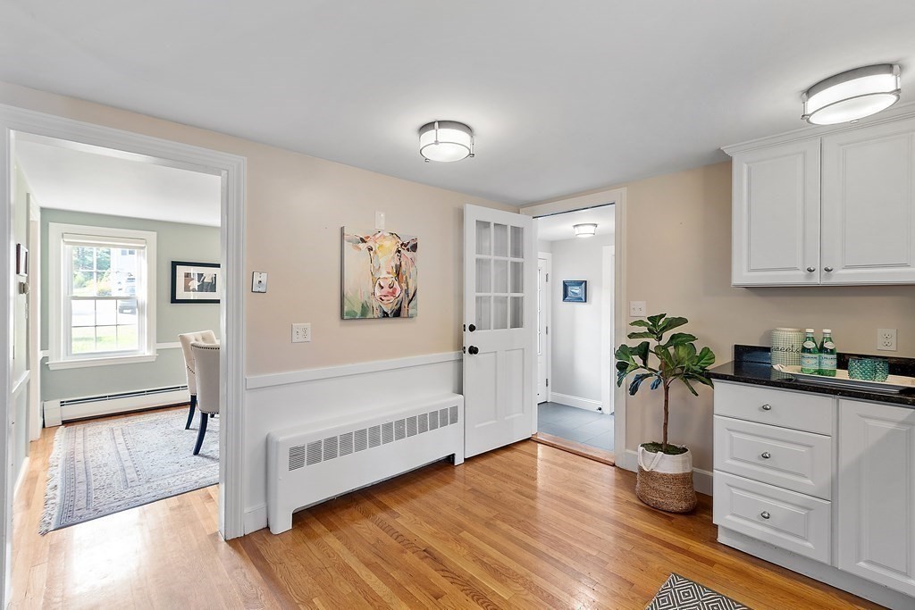 21 Oneida Road Acton, MA 01720 - Photo 10 of 39 a hallway with wooden floor and cabinet