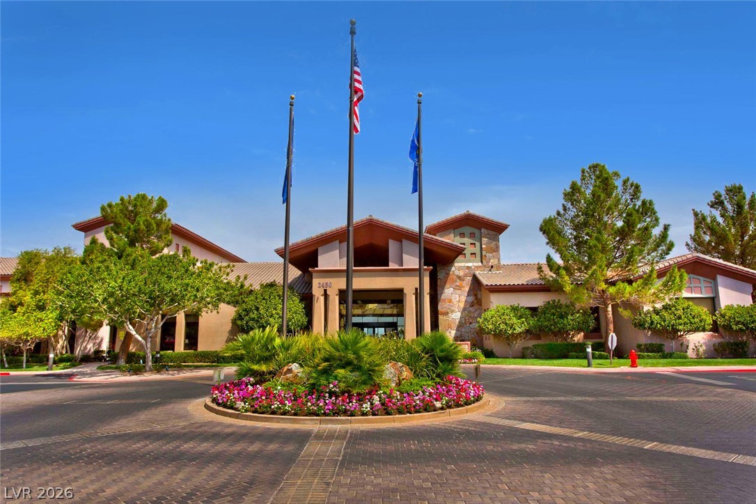 1680 Fieldbrook Street Henderson, NV 89052 - Photo 25 of 32 An elegant circular driveway guides visitors toward the impressive clubhouse entrance.
