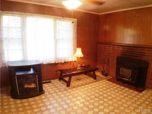 2737 Poole Road Raleigh, NC 27610 - Photo 3 of 15 a living room with furniture a fireplace and a window