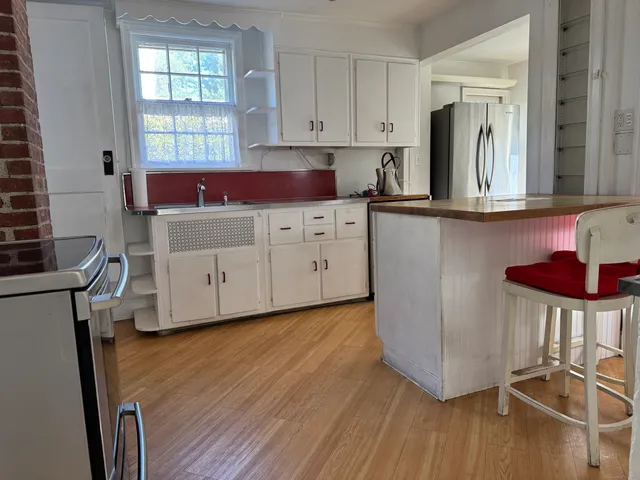 a kitchen with cabinets a sink and appliances