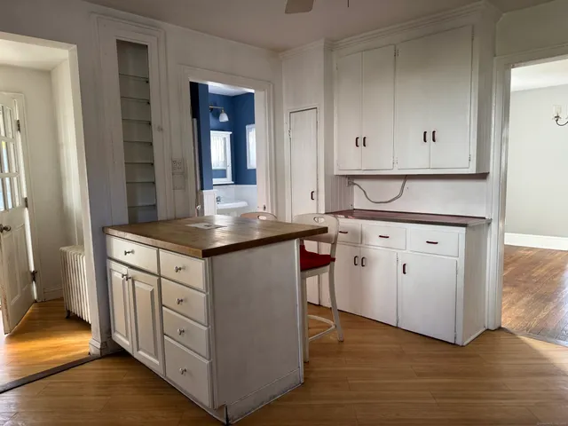 a kitchen with granite countertop white cabinets and a sink