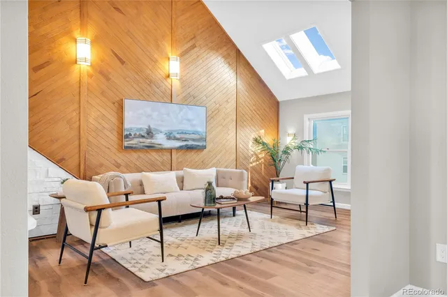 a living room with furniture and a painting on the wall