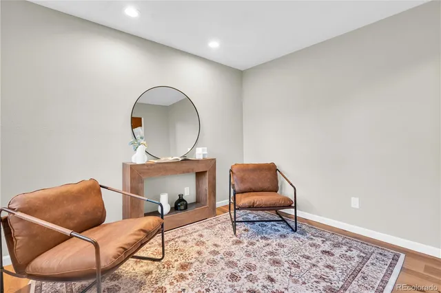 a living room with furniture and a chair