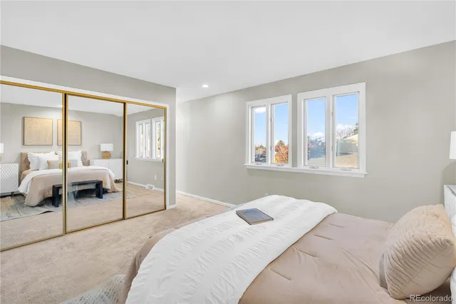 a bedroom with a large bed and a window