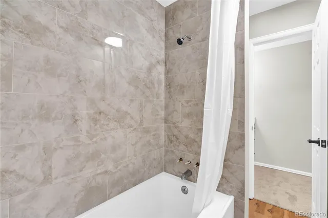 a bathroom with a bathtub and shower