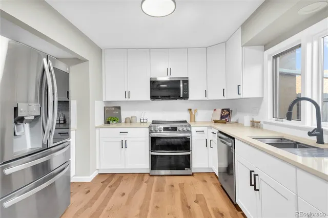 a kitchen with a sink stove and refrigerator
