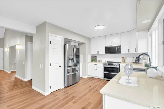 a kitchen with a refrigerator stove and sink